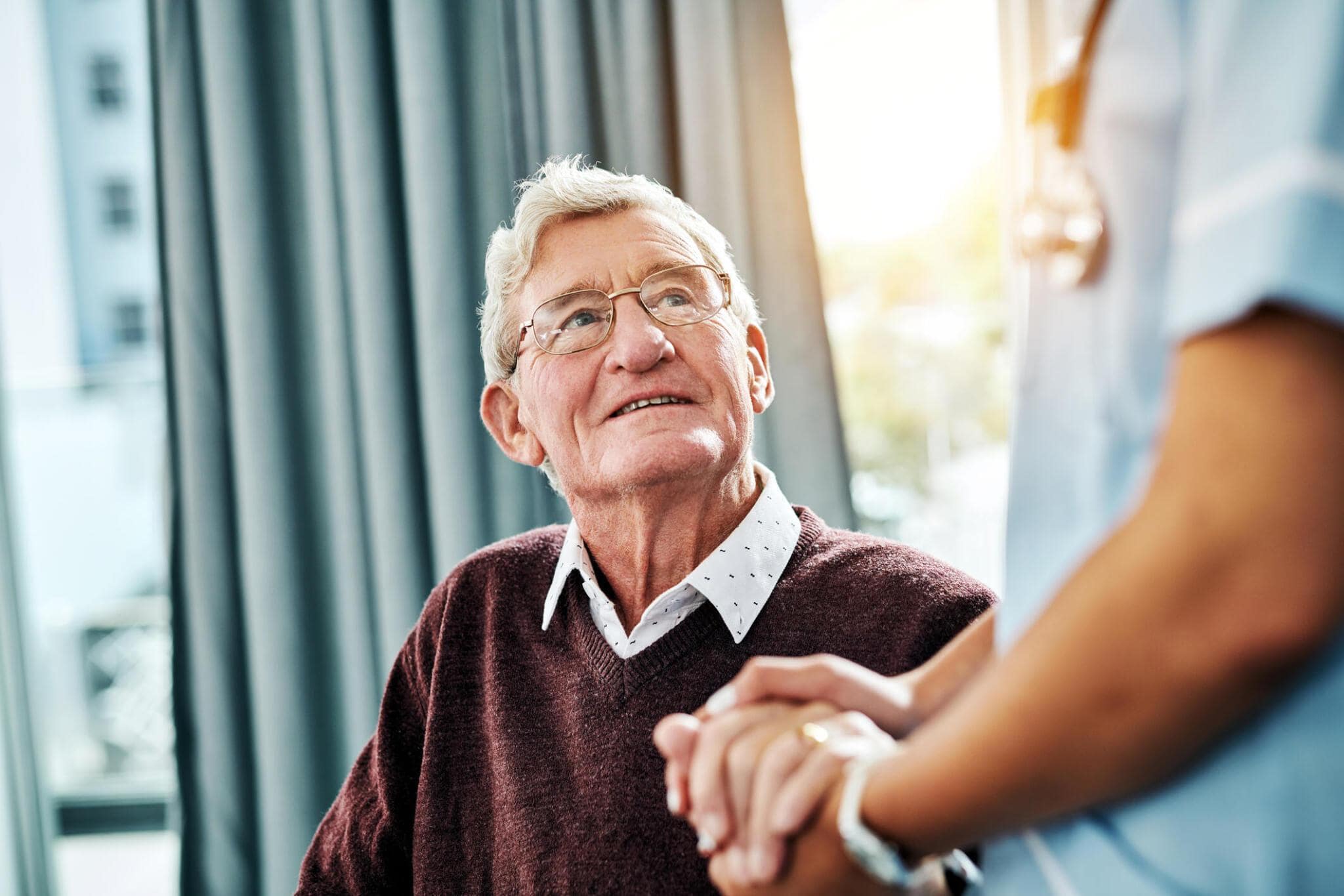 Elderly man looking up while smiling